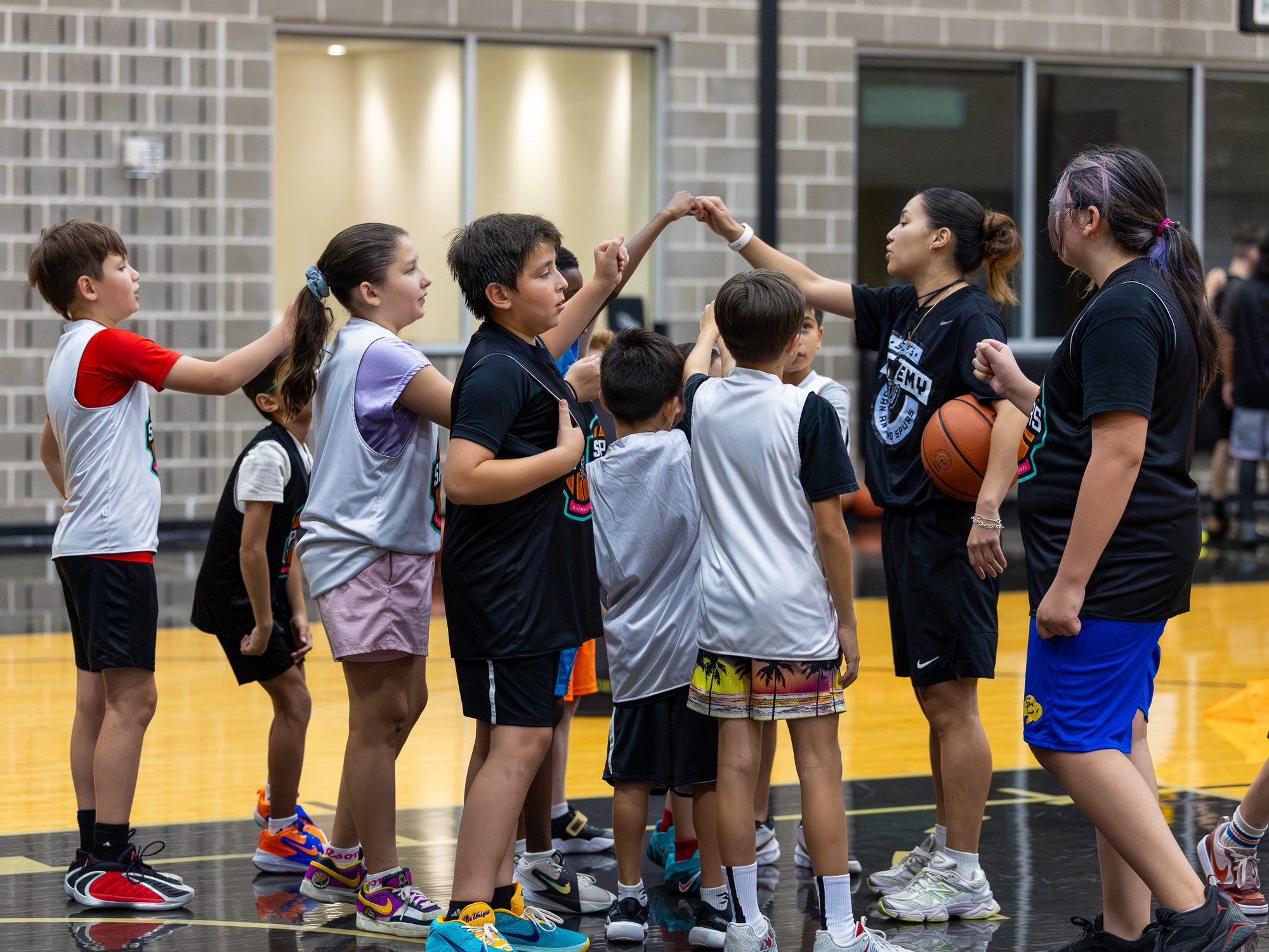 Youth basketball team huddle showing connection and focus
