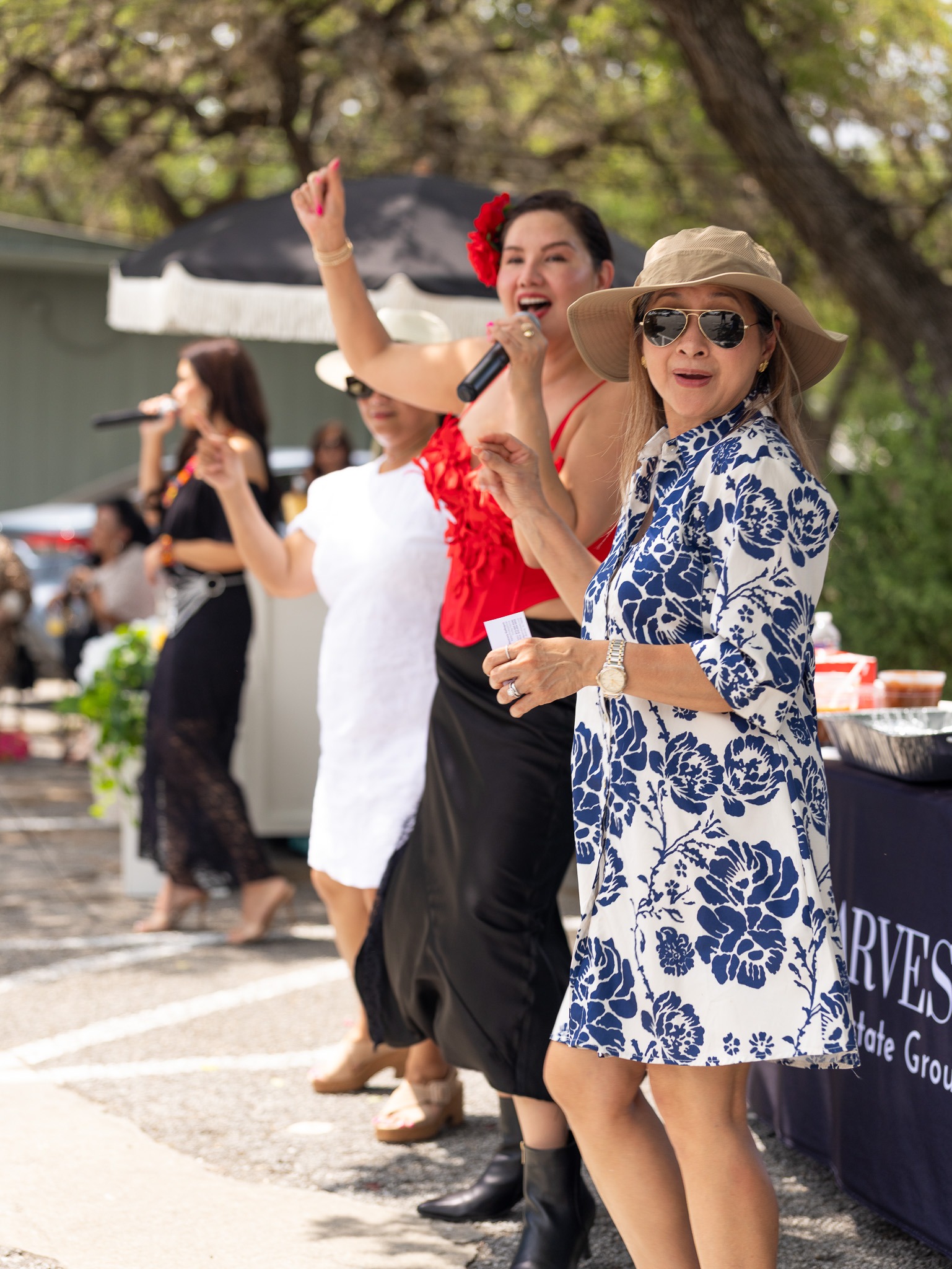 Guests dancing together during a colorful outdoor celebration