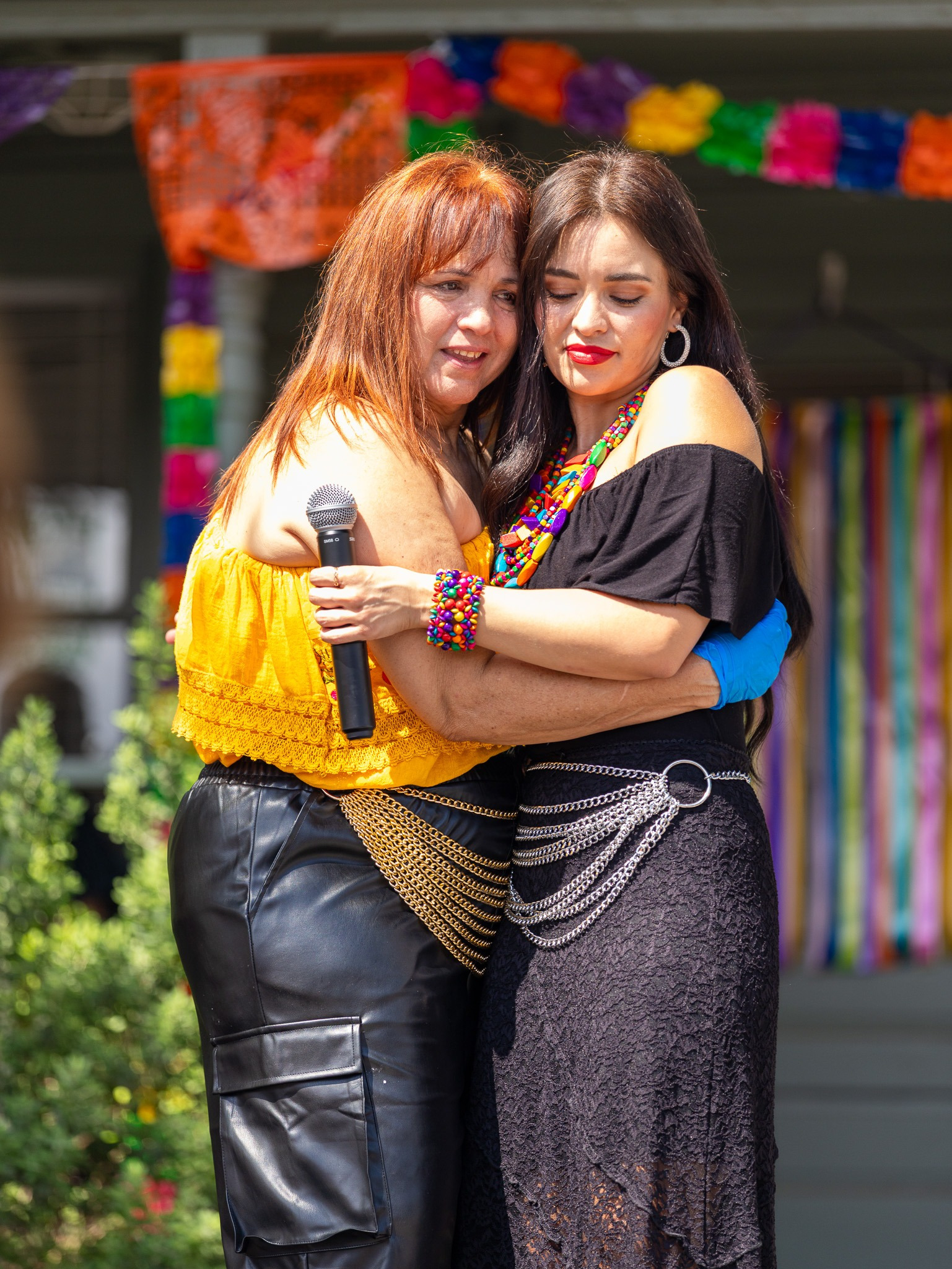 Two women sharing an emotional embrace during a celebration